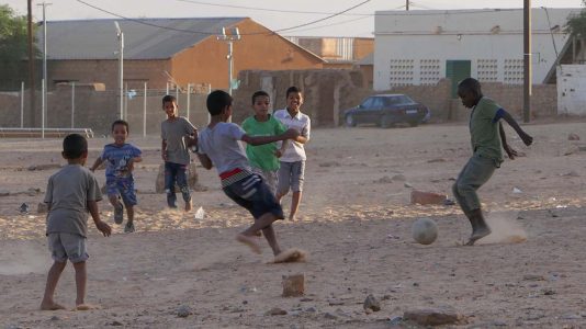 Boys Playing Football on Sandy Lot in Atar - Mauritania