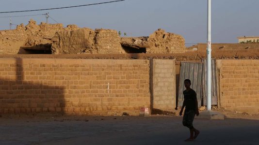 Silhouetted Boy Walking Down Street in Atar - Mauritania